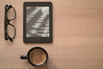 Book glass tablet kindle table office mug of coffee
