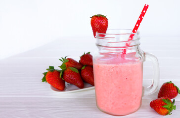 Strawberry yogurt fruit juice smoothie pink colorful fruit juice milkshake blend beverage healthy high protein the taste yummy In glass drink episode morning on white wood background.