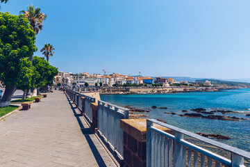 Obraz premium Alghero old town, Alghero street view on a beautiful day. Alghero, Italy. Panoramic aerial view of Alghero, Sardinia, Italy.