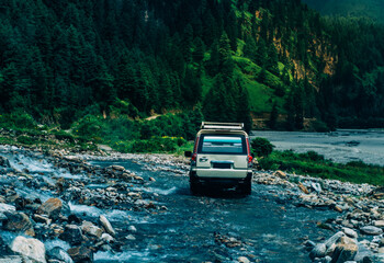 Off road car on the water fall in the mountain
