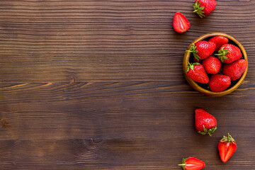 Bowl of ripe strawberry with leaves. Berry flay lay, top view