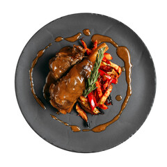Isolated plate of stewed lamb meat with vegetables and sauce