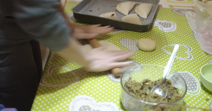 View homemade preparation of panzerotti also called calzone during spreading the dough 