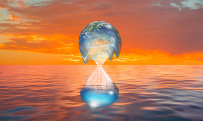Global warming concept - Planet Earth on hourglass is slowly melting with The whole earth is...