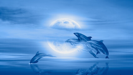 Fototapeta na wymiar Silhoutte of dolphins jumping up from the sea at sunset with full moon 