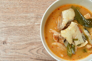 boiled salmon fish in spicy tom yum soup on bowl