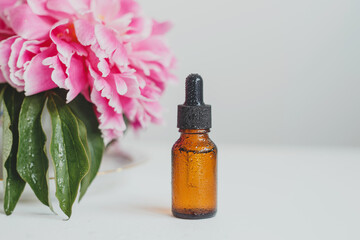 A brown glass bottle of serum, essential oil or other cosmetic product. Natural organic cosmetic packaging, skin care concept.