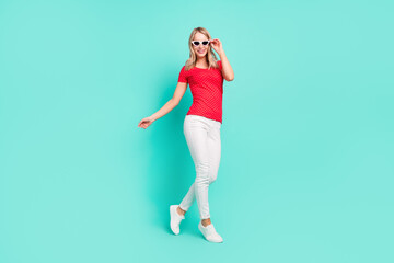 Full length body size photo woman walking wearing stylish sunglass summer isolated bright teal color background