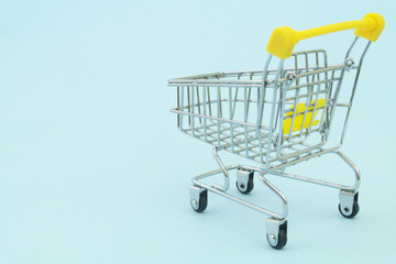 Shopping cart on blue background with space for text, buy and sale concept.	