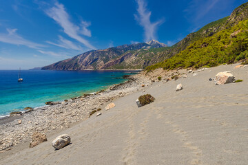 Sand dunes beneath high mountains east of Agia Roumeli on the south coast of the Greek island of...