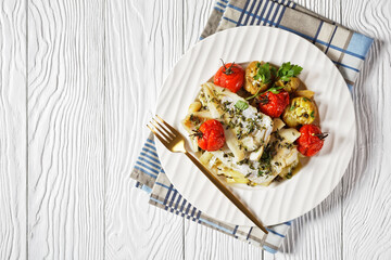 white fish fillets with veggies on a plate