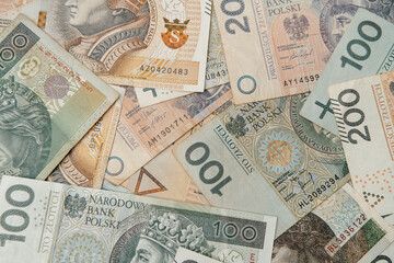 Flat lay of polish national money bills zloty. 200zl and 100zl zl bills. Macro close up texture of national bank of poland banknotes