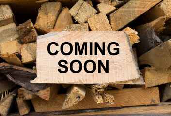 Wall firewood. Background of dry chopped firewood logs in a pile and plate with text Coming Soon