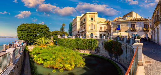 The Fountain of Arethusa and Siracusa (Syracuse) in a sunny summer day. Sicily, Italy. The Fountain...