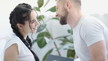 Obraz premium cheerful young couple looking at each other at home.