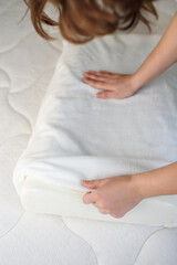 Women's hands put a cover on the orthopedic pillow with cooling gel. Protecting the foam pillow...