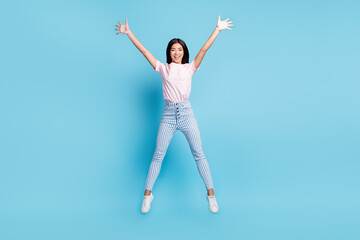 Fototapeta na wymiar Full size photo of young cheerful girl happy positive smile active jump up isolated over blue color background