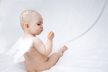 small child, infant, with angel wings on a white background.