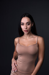Fototapeta premium portrait of a young woman in the studio on a dark background