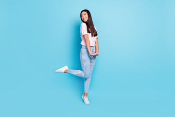 Fototapeta na wymiar Full size profile side photo of young attractive girl happy positive smile look empty space isolated over blue color background