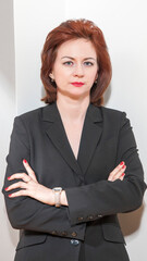 Young business woman in a business suit on a white background
