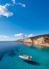 Sailboat at anchor in the clear sea of Lakoudi on the southeast coast of the remote Greek island of Gavdos south of Crete in the Libyan Sea