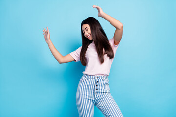 Naklejka premium Photo of young excited girl happy positive smile enjoy music dance party isolated over blue color background