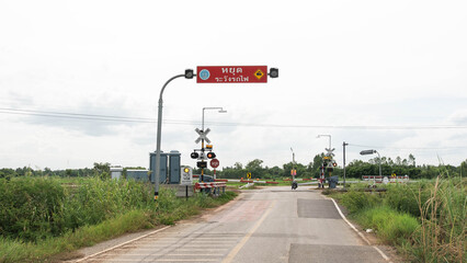 A railway crossing with a warning sign before the train passes.