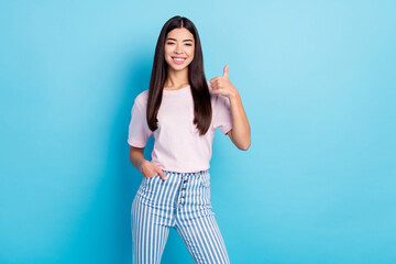 Fototapeta premium Photo of young girl happy positive smile show thumb-up advert advice perfect fine isolated over blue color background