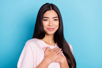 Photo of young girl happy positive smile hands on chest appreciate grateful isolated over blue color background