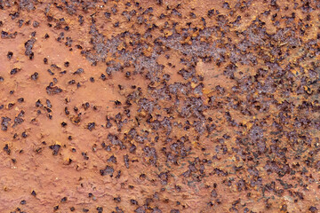 Rusty steel surface, close up view, background showing a worn old detail.