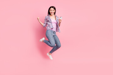 Full length body size photo girl in checkered shirt keeping cellphone gesturing like winner...