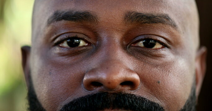 African black man close-up eyes looking at camera, real people