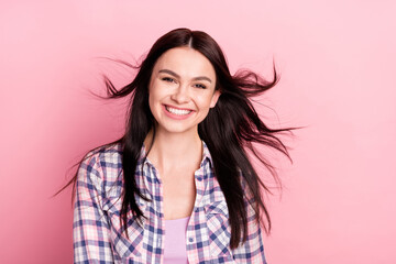 Photo portrait girl in checkered shirt smiling flying hair isolated pastel pink color background