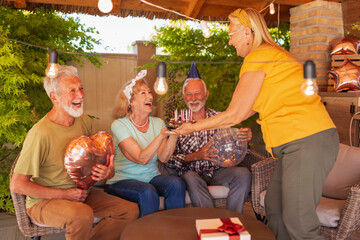 Elderly people throwing a surprise birthday party for a friend