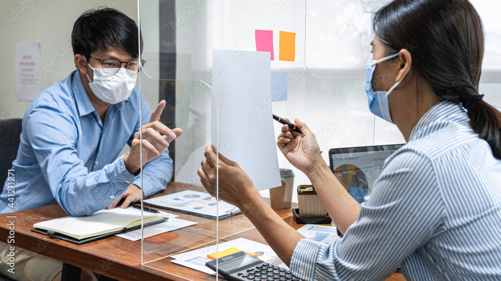 Poster Two business colleagues showing and pointing on financial document for discussion in new business