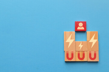 Wooden blocks with magnet icons pull a person in a row blocks. Recruiting and search talent workers...
