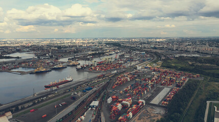 Naklejka na ściany i meble Aerial view of high-tech modern seaport with cranes and loaders