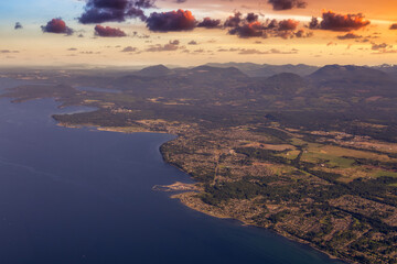 Aerial View of Qualicum Beach from an Airplane on the shore of Strait of Georgia in Vancouver Island, British Columbia, Canada. Colorful Sunset Sky Art Render.