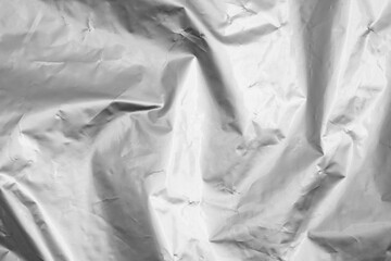 Black and white shiny crumpled foil texture, abstract shapes for background.