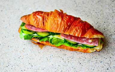 Delicious croissant with butter and salad