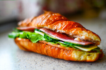 Delicious croissant with butter and salad