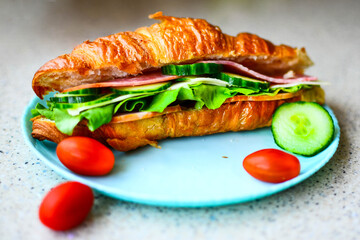 Delicious croissant with butter and salad