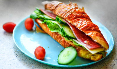 Delicious croissant with butter and salad