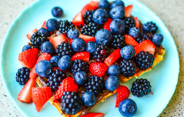 Delicious Waffles with fresh berries and chocolate