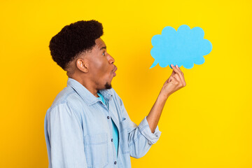 Photo of impressed funky dark skin man wear jeans shirt looking holding mind cloud empty space isolated yellow color background