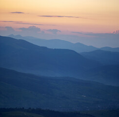 Panorama, smoky silhouette of the Carpathian mountains at sunset