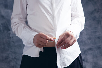 Fototapeta premium young woman takes off her clothes