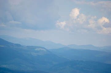 Fototapeta na wymiar Panorama of blue mountains in spring in the haze