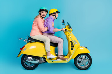 Fototapeta na wymiar Profile side view of attractive cheerful amazed couple riding bike having fun isolated over bright blue color background